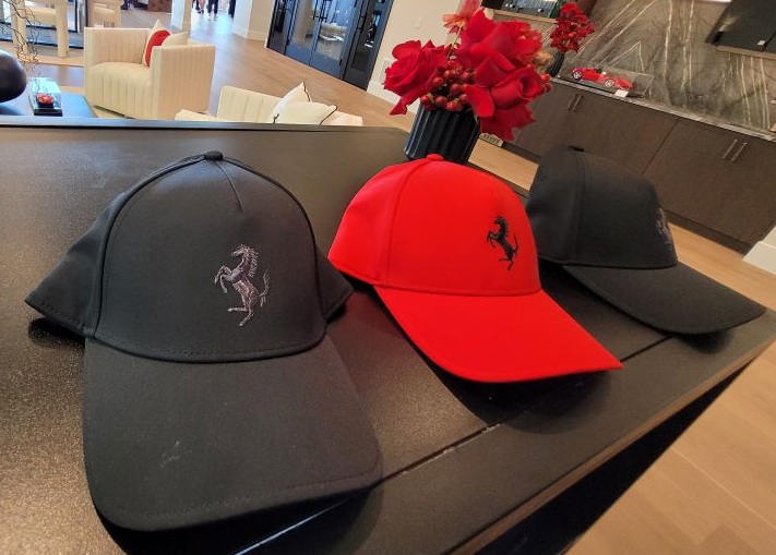 Black and red embroidered hats displayed on the counter