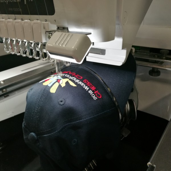 Live Event Embroidery - Elementary State Chess Championship in Pasco, Washington. Embroidering Chess-themed hats and jackets.